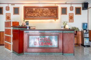 a hotel saaving sign on top of a television at Rehat at Hotel Sabang in Bandung