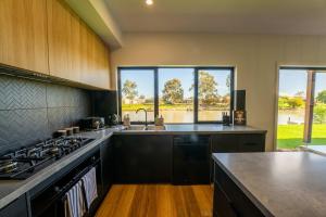 a kitchen with a sink and a stove top oven at 10 Jefferson Court in Wellington East