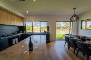 a kitchen with a table with wine glasses on it at 10 Jefferson Court in Wellington East