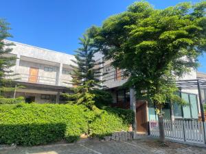 an apartment building with a tree in front of it at Come Moon Loft Hotel in Phrae +21 photos