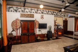 a living room with wooden cabinets and a tv at Ella Mount Heaven in Ella