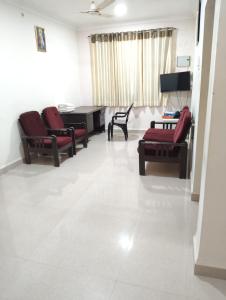 a living room with chairs and a table and a couch at Rich nest apartments colva in Colva