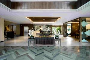 a lobby of a hotel with flowers on the floor at The Vira Bali Boutique Hotel & Suite in Kuta +89 photos