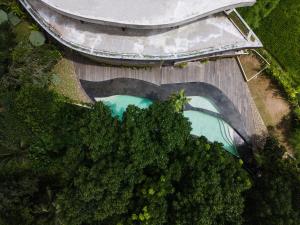 an overhead view of a pool of water next to trees at Utopia Concept Bali - Adults Only in Ubud