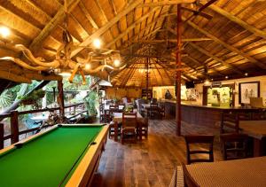 a bar with a pool table in a restaurant at Mokolodi Backpackers - Relax in Nature near Gaborone with Pool, Fast WiFi, Coworking Space & Garden Chalets - Tranquillity Redefined in Gaborone +12 photos