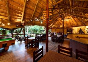 a dining room with a pool table and a pool tablesktop at Mokolodi Backpackers - Relax in Nature near Gaborone with Pool, Fast WiFi, Coworking Space & Garden Chalets - Tranquillity Redefined in Gaborone