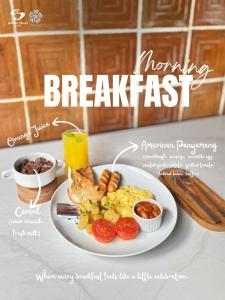 a breakfast plate of breakfast food on a table at Sandat Hotel Legian in Legian