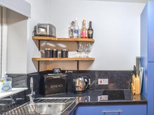 a kitchen with a sink and a counter top at Corner Spot in Hednesford