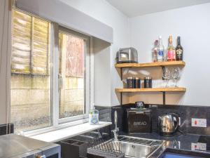 a kitchen with a sink and a window at Corner Spot in Hednesford