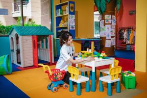 a young girl playing with toys at a table in a play room at Holiday Inn Resort Batam by IHG in Sekupang
