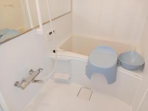 a white bathroom with a toilet and a sink at GuestHouseさがら丸 in Niijimamura +40 photos