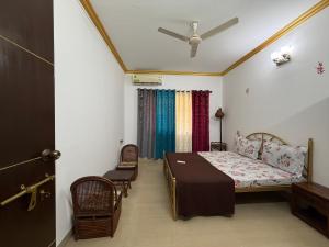 a bedroom with a bed and a ceiling fan at Goa Homeland 3 double bed Calangute in Calangute +71 photos