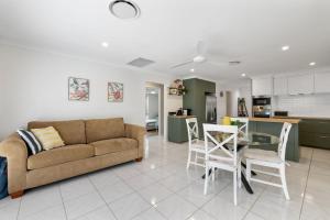 a living room with a couch and a table at The Salty Anchor in Banksia Beach