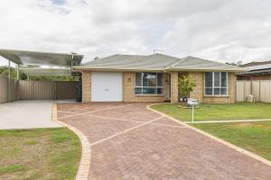 a house with a basketball court in the driveway at The Salty Anchor in Banksia Beach