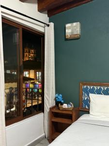 a bedroom with a bed and a window at Hotel las Orquideas in Valle de Bravo