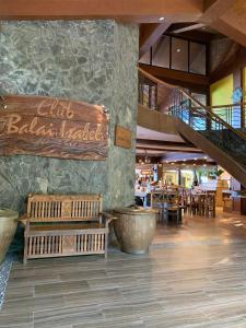 a restaurant with a bench and tables and a staircase at Club Balai Isabel Front Taal Lake & Volcano View in Talisay