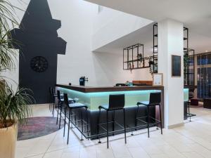 a bar in a lobby with stools and a counter at Hotel Mercure Graz City in Graz