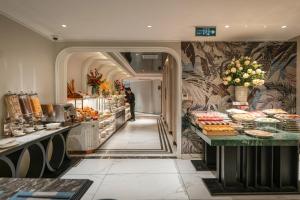 a buffet line with food on display in a restaurant at Heritage Ham Long Hotel and Spa in Hanoi