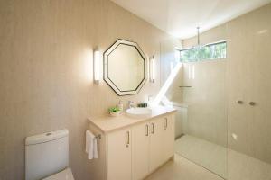 a bathroom with a sink and a mirror and a toilet at Gumleaf Villa Hosted by Halls Gap Accommodation in Halls Gap +13 photos