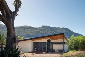 a house with a mountain in the background at Gumleaf Villa Hosted by Halls Gap Accommodation in Halls Gap