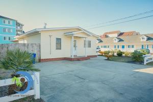 a house with a driveway in front of it at Cg Beach Bungalow #3 in Myrtle Beach