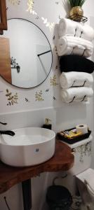 a bathroom with a sink and a mirror and towels at Casa Campana in Concepción de Ataco +30 photos