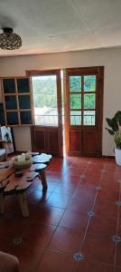 a living room with a tiled floor and a table at Casa Campana in Concepción de Ataco