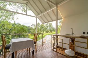 a room with a table and a sink on a balcony at Örök Landscape Hotel in Rionegro