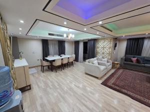 a living room with a table and a dining room at luxury hotels home in Cairo +5 photos