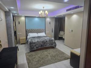 a bedroom with a large bed and a chandelier at luxury hotels home in Cairo