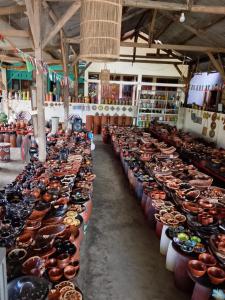 a large room filled with lots of pots and bowls at SKY SUNSET Bungalows in Tetebatu
