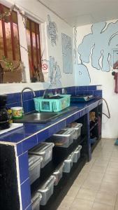 a blue counter with dishes on it in a kitchen at Casa bohio surf in Jacó +45 photos