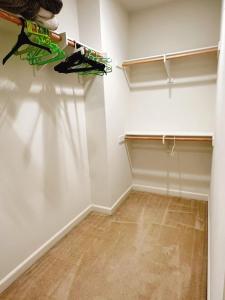 an empty room with a closet with shelves at FB Master in Irvine