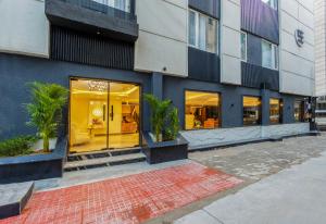 a store front of a building with glass windows at Hotel Bella Express in New Delhi