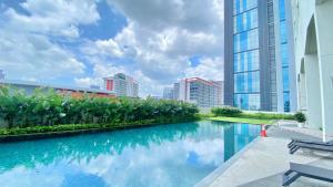 a swimming pool in the middle of a city with tall buildings at UNA Serviced Apartment by manatidur in Kuala Lumpur