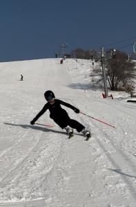 a person is skiing down a snow covered slope at Kainar Glamp Домик в горах с террасой и прекрасным видом на горы in Besqaynar