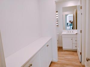 a white bathroom with a sink and a mirror at FB Master in Irvine +7 photos