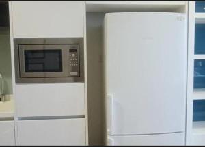 a microwave and a refrigerator in a kitchen at Platinum Face suits in Kuala Lumpur