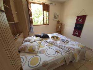 a bedroom with a large bed in a room at Ti Sucrier Jaune - Douceur caraïbe vue mer in Le Carbet