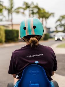 a person wearing a helmet sitting on a scooter at Tasman Holiday Parks - Jervis Bay in Huskisson