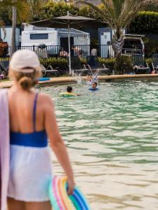 a woman in a bathing suit in a swimming pool at Tasman Holiday Parks - Jervis Bay in Huskisson