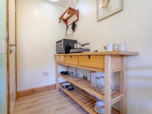 a kitchen with a table with a microwave on it at Beinn Uidhe Studio Apartment - Uk49100 in Inchnadamph