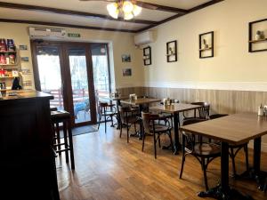a dining room with wooden tables and chairs at Silk Way in Almaty