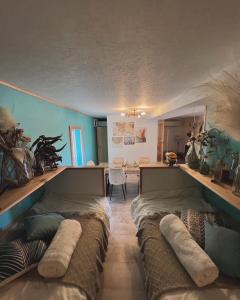 two beds in a room with blue walls at Gaju Camp in Wakayama