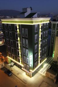 a hotel building with lights on it at night at Capital Tirana Hotel Bruçi in Tirana