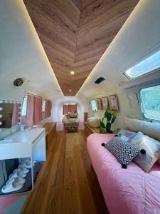 a living room with a couch and a sink in a camper at Gaju Camp in Wakayama