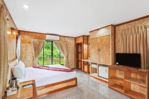 a bedroom with a bed and a flat screen tv at Chanta Boutique Place in Ubon Ratchathani +29 photos