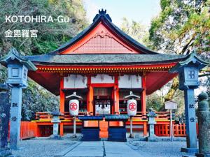 a building with an orange and white at Entire House-otonarisan-一軒家貸切- 駐車場無料 in Takamatsu