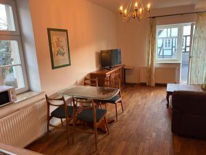 a living room with a table and a television at Hugo zwei in Warburg +3 photos