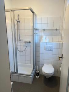 a bathroom with a shower and a toilet at Hugo zwei in Warburg